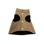 Quilted dog coat with button closures on a white background