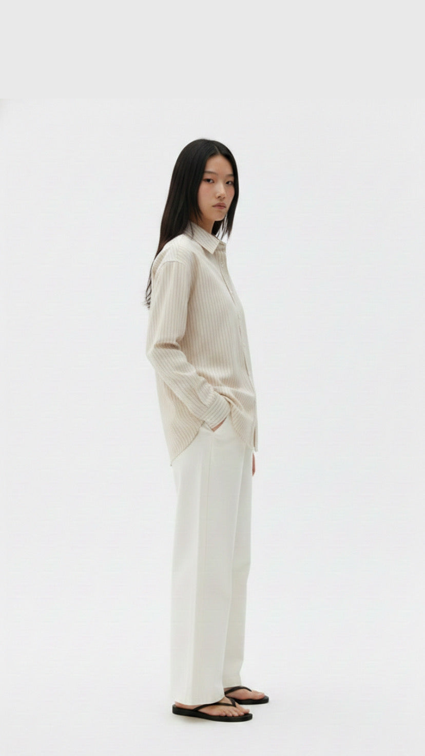 Woman wearing a white outfit on a plain background