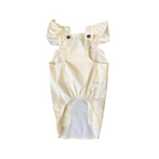 Beige baby romper with ruffled sleeves on a white background