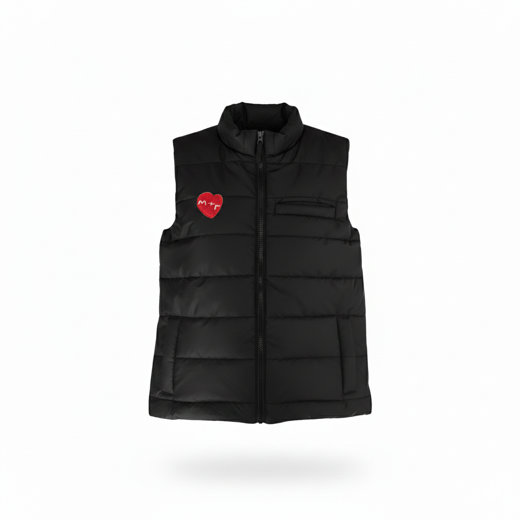 Black puffer vest with a red heart patch on a white background