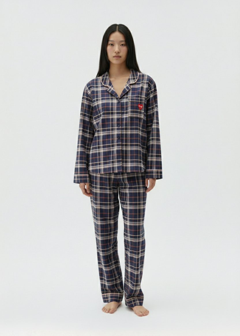 Person wearing a plaid pajama set on a white background