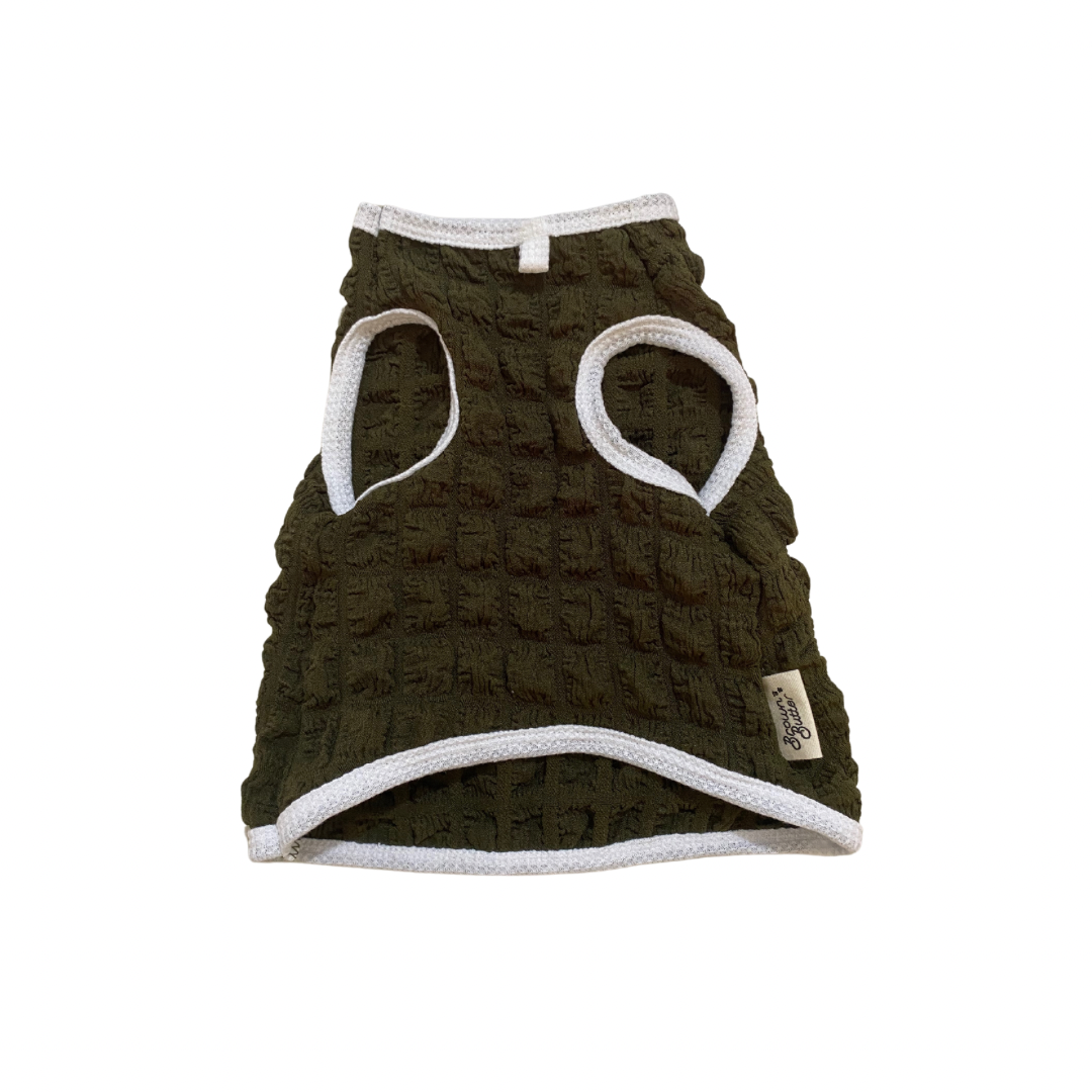 Dark green textured dog vest with white accents on a white background