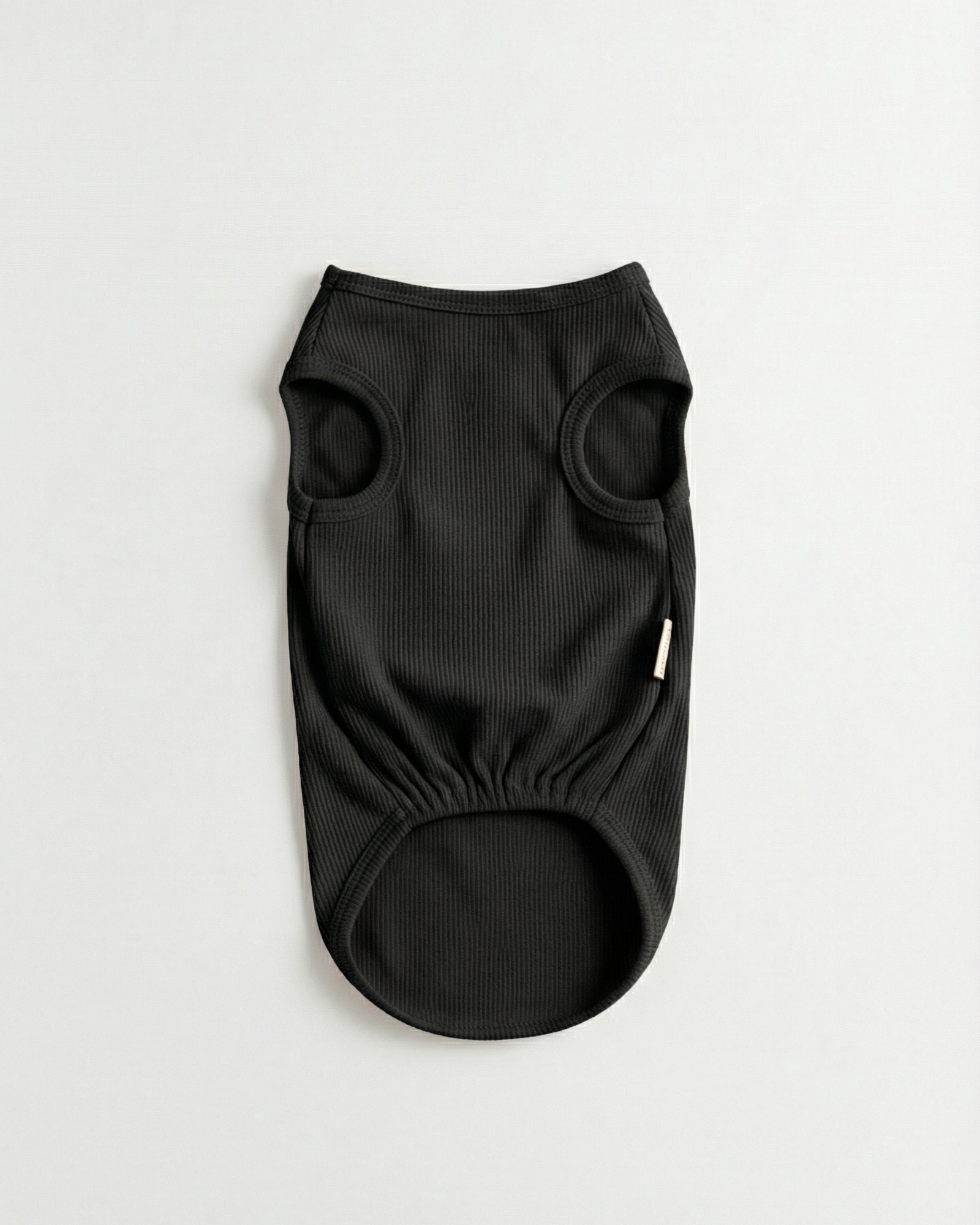 Black dog sweater on a light gray background