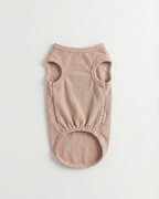 Pink baby romper on a light gray background