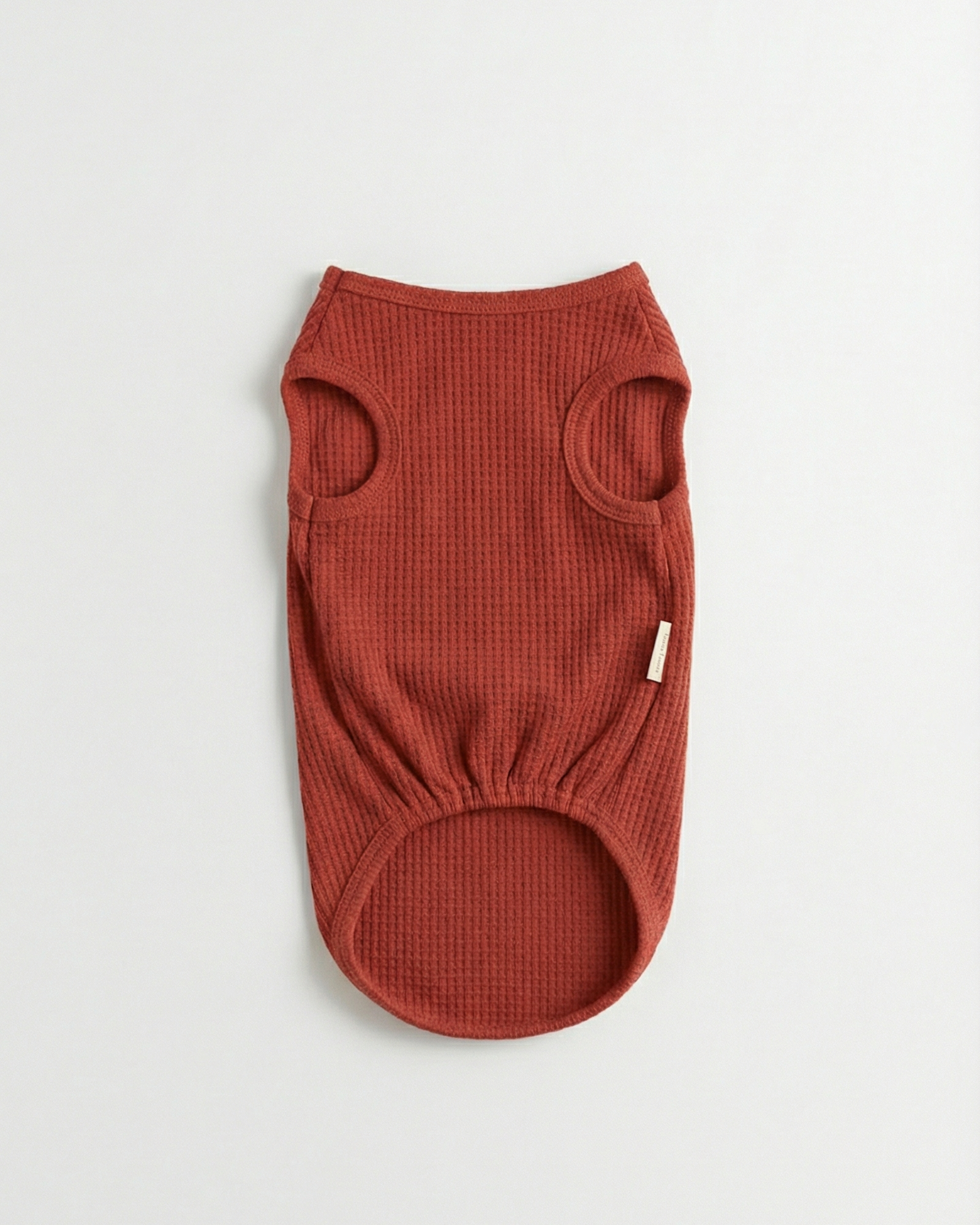 Brown ribbed dog sweater on a light gray background