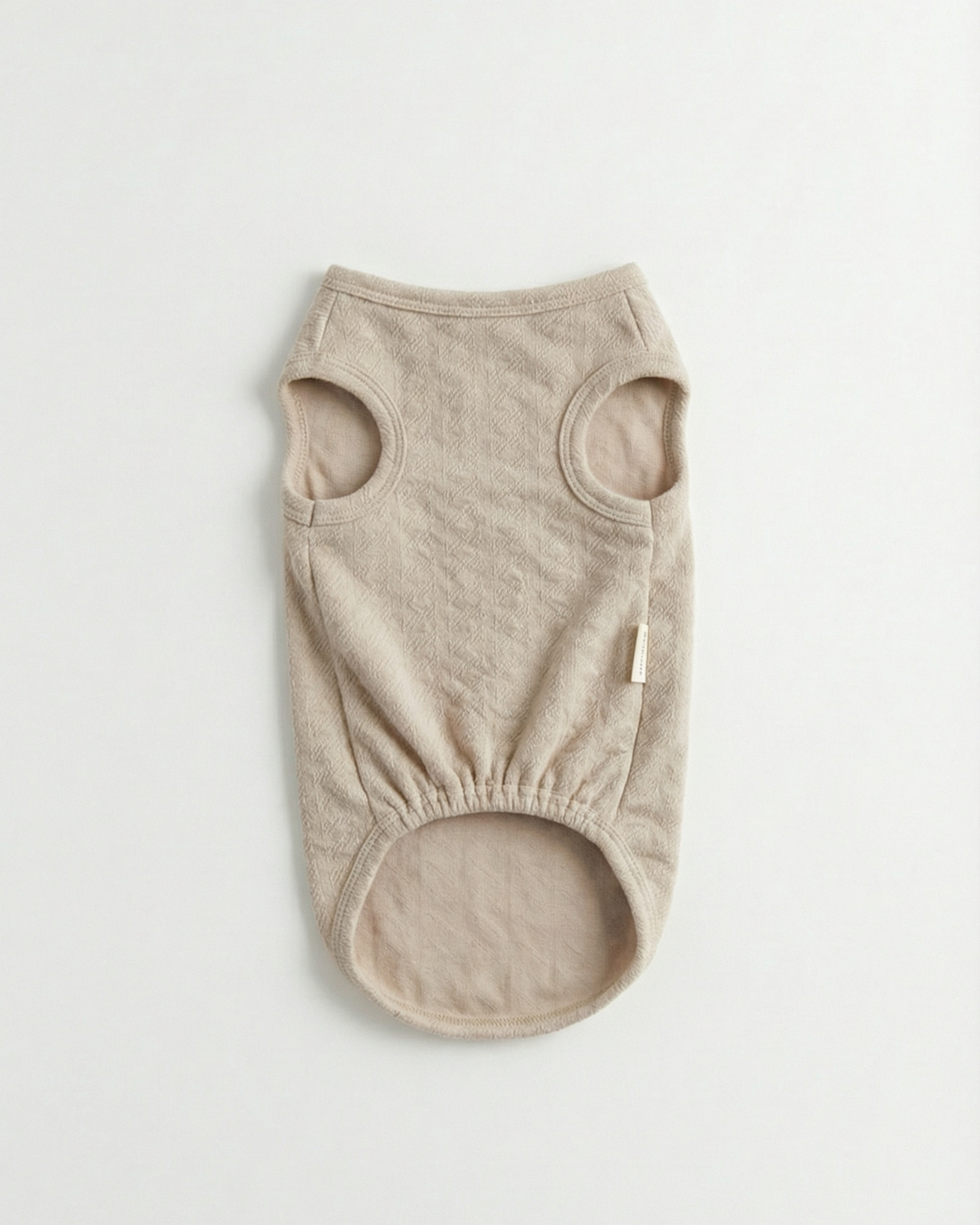 Beige dog vest on a light gray background