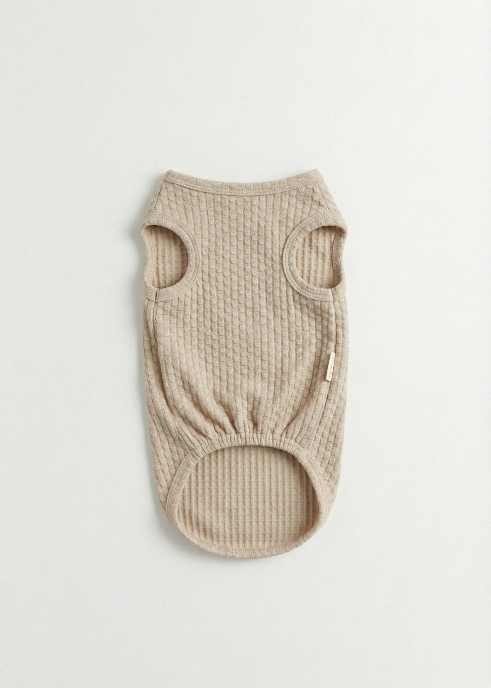 Beige ribbed dog sweater on a light gray background
