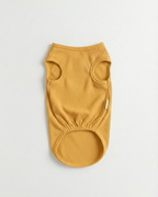 Yellow ribbed dog sweater on a light gray background